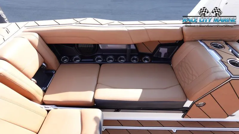 Slide: The Image of 2023 Malibu 26 LSV boat interior with tan leather seating and cup holders. - 44