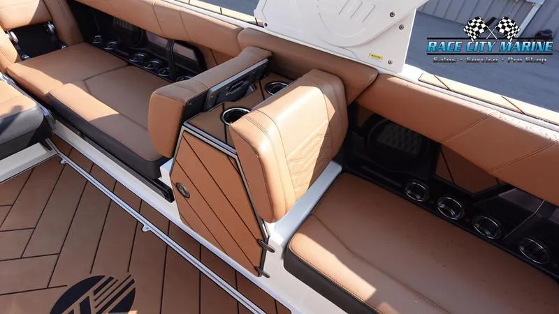 Slide: The Image of 2023 Malibu 26 LSV boat interior with tan leather seating and cup holders. - 47