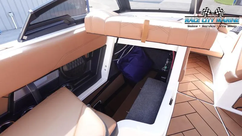 Slide: The Image of 2023 Malibu 26 LSV interior storage area with tan seating and flooring. - 48