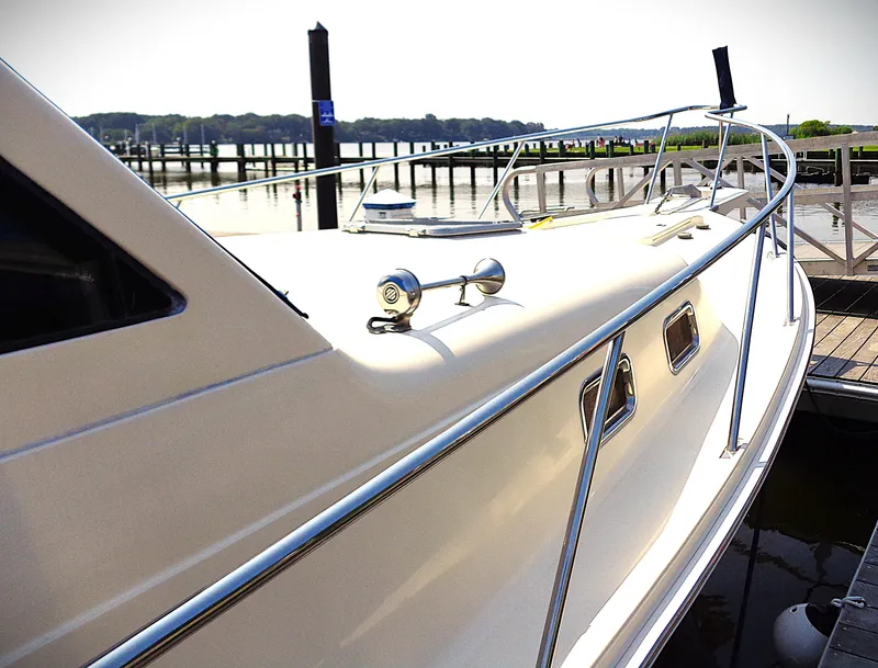 Slide: The Image of 2005 Mainship Pilot 30 Rum Runner II docked at marina, side view. - 12
