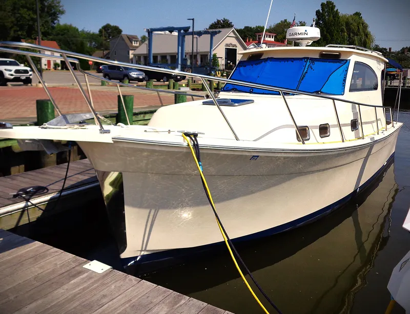 Slide: The Image of 2005 Mainship Pilot 30 Rum Runner II docked at marina. - 14