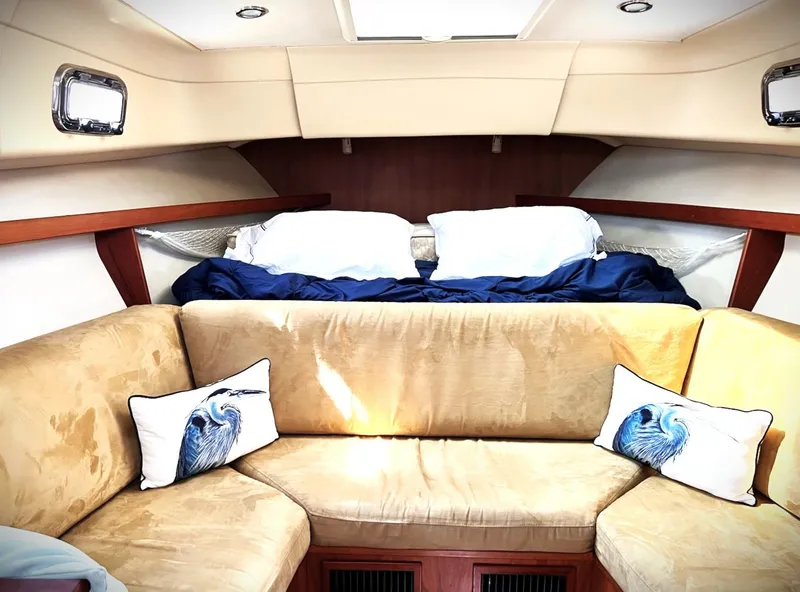 Slide: The Image of Interior of 2005 Mainship Pilot 30 Rum Runner II with cozy seating and decorative pillows. - 3