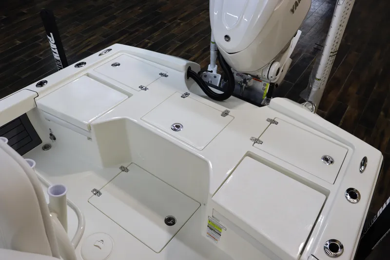 Slide: The Image of 2025 Pathfinder 2500 Hybrid boat deck with storage compartments and outboard motor. - 13