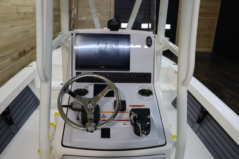 Slide: The Image of 2025 Pathfinder 2500 Hybrid boat console with steering wheel and navigation screen. - 21