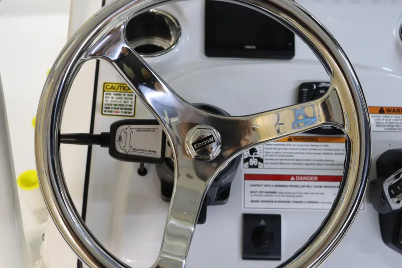 Slide: The Image of Steering wheel of 2025 Pathfinder 2500 Hybrid boat with control panel and caution labels. - 22