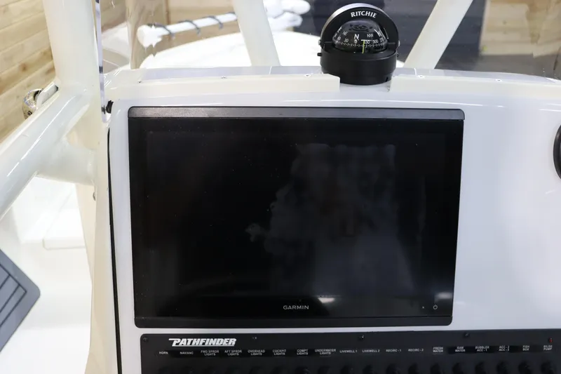 Slide: The Image of Pathfinder 2500 Hybrid 2025 dashboard with Garmin display and Ritchie compass. - 25