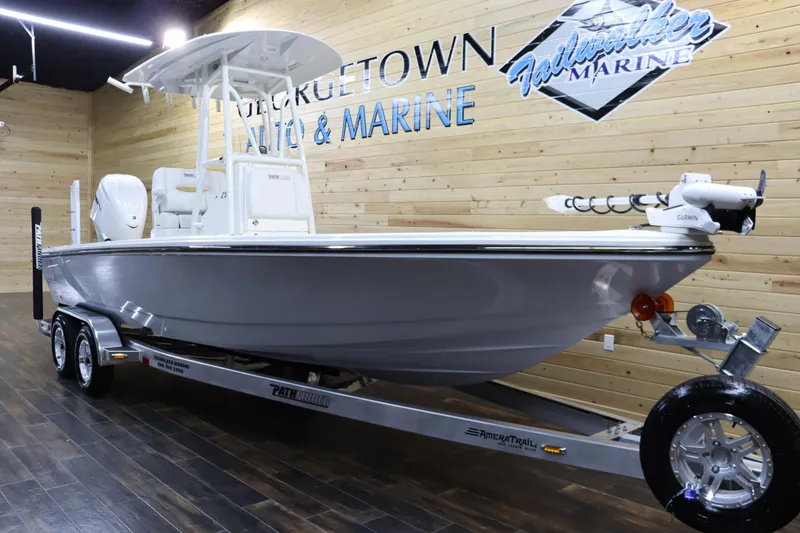 Slide: The Image of 2025 Pathfinder 2500 Hybrid boat on display in a showroom. - 5