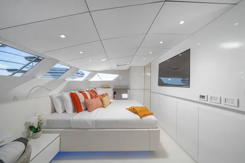 Slide: The Image of Luxurious Sunreef 70 yacht bedroom, modern design, 2016 model, with elegant white and orange accents. - 16