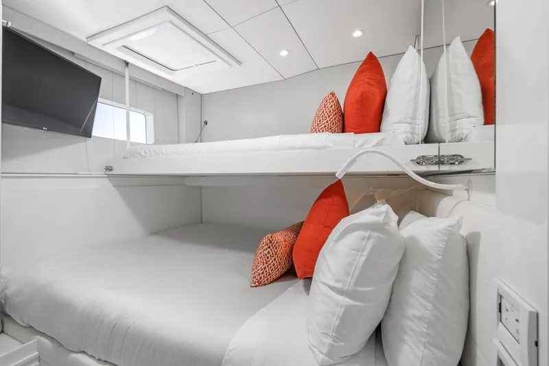 Slide: The Image of Luxurious Sunreef 70 yacht cabin with modern bunk beds and vibrant orange accents. - 22