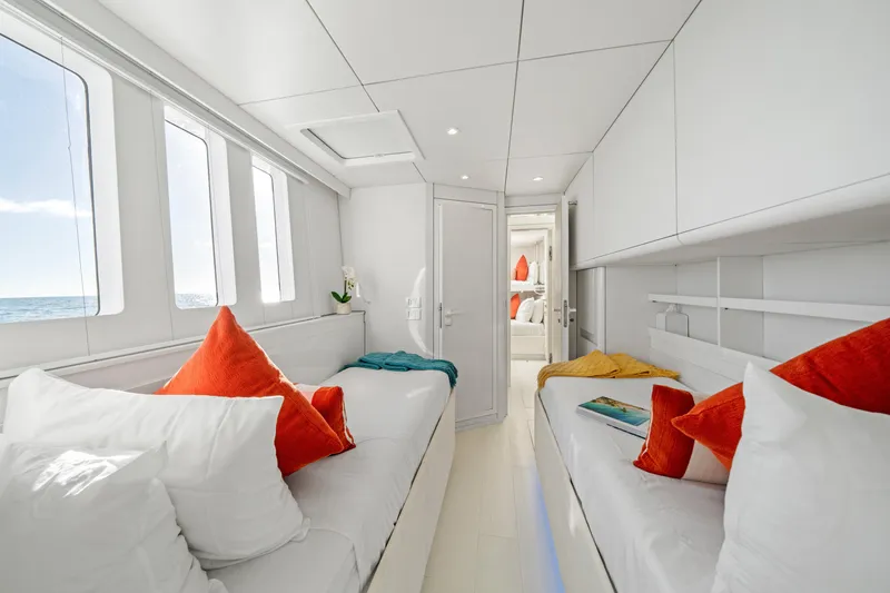 Slide: The Image of Luxurious Sunreef 70 yacht interior, 2016 model, featuring cozy beds and vibrant decor. - 24