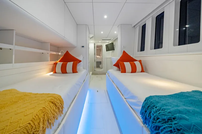 Slide: The Image of Luxurious Sunreef 70 yacht cabin with twin beds, vibrant pillows, and modern decor, 2016 model. - 25
