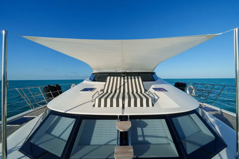 Slide: The Image of Luxurious Sunreef 70 yacht deck with sunshade and striped lounge chair, 2016 model. - 30
