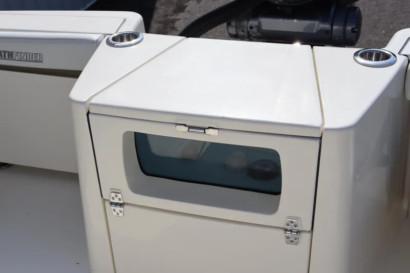 Slide: The Image of Pathfinder 2700 Open 2025 boat storage compartment with window and cup holders. - 12