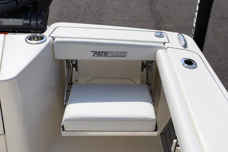 Slide: The Image of 2025 Pathfinder 2700 Open boat seat with cup holder and logo detail. - 13