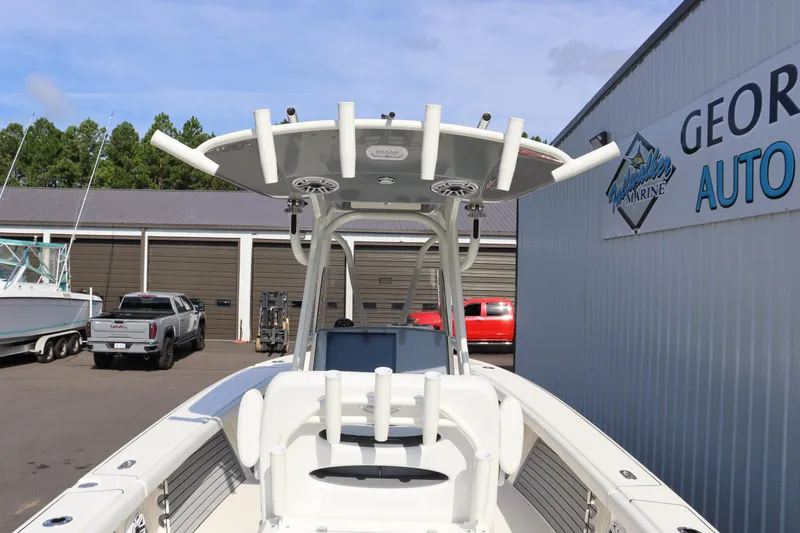 Slide: The Image of 2025 Pathfinder 2700 Open boat at dealership, featuring T-top and rod holders. - 15