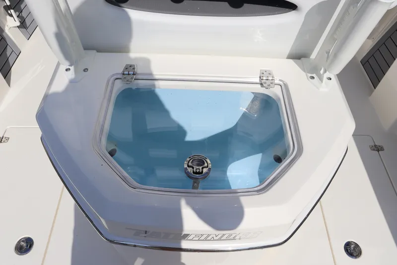 Slide: The Image of 2025 Pathfinder 2700 Open boat livewell with clear lid and blue interior. - 19