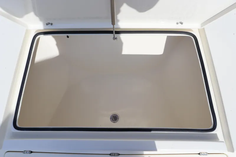 Slide: The Image of Pathfinder 2700 Open 2025 boat storage compartment, open lid, spacious interior. - 29