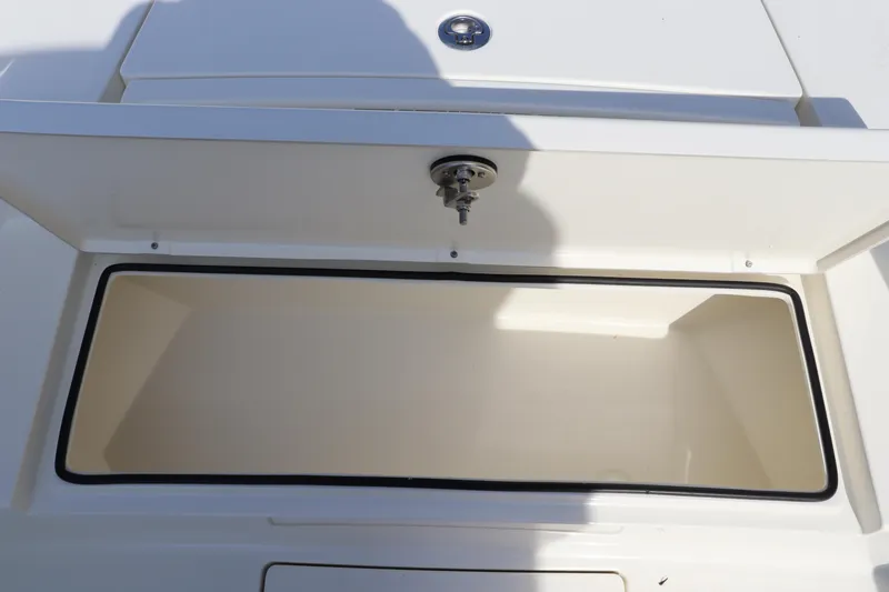 Slide: The Image of Pathfinder 2700 Open 2025 boat storage compartment with open lid. - 30