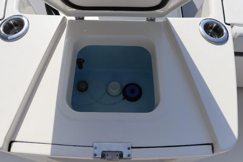 Slide: The Image of Pathfinder 2700 Open 2025 boat livewell with cup holders, open lid view. - 35