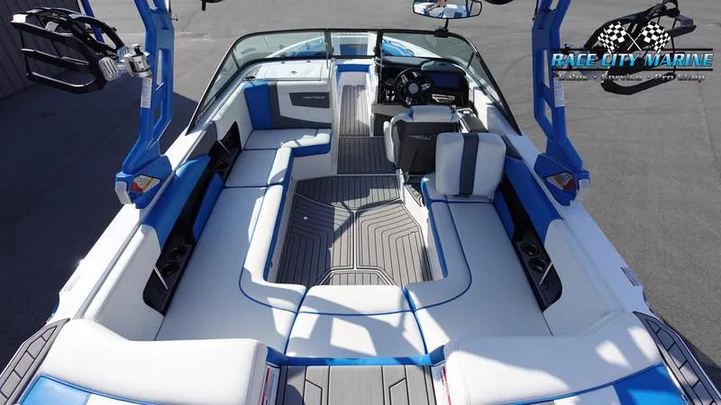 Slide: The Image of 2019 Nautique Super Air Nautique 230 interior, blue and white seating, Race City Marine logo. - 16