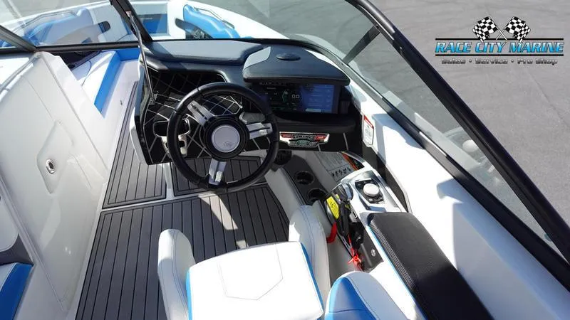 Slide: The Image of 2019 Nautique Super Air Nautique 230 boat interior with modern dashboard and steering wheel. - 19