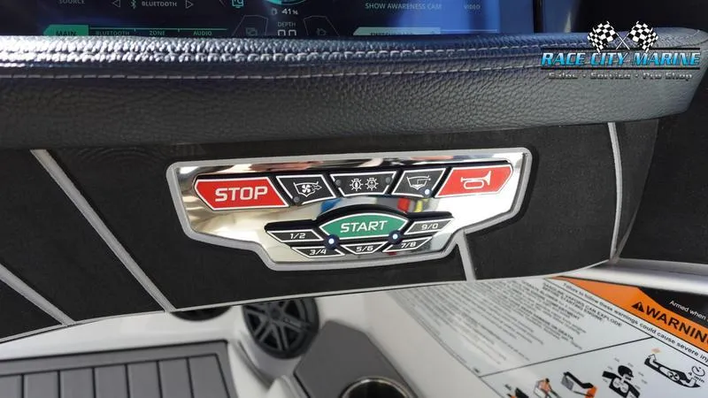 Slide: The Image of Control panel of 2019 Nautique Super Air Nautique 230 boat with start and stop buttons. - 21
