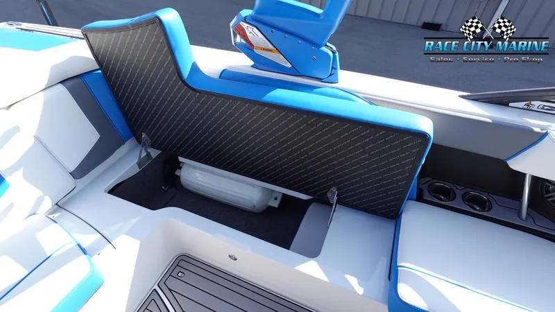 Slide: The Image of 2019 Nautique Super Air Nautique 230 interior storage compartment with blue and white seating. - 26