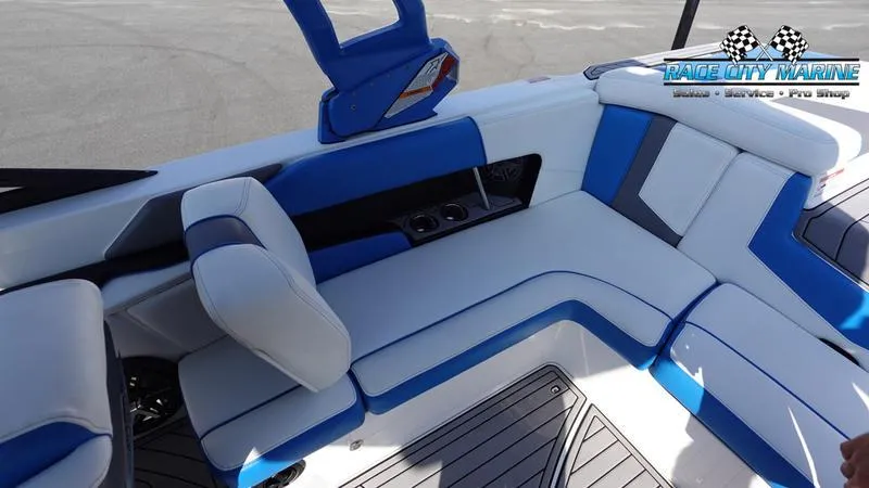 Slide: The Image of 2019 Nautique Super Air Nautique 230 interior with blue and white seating. - 27