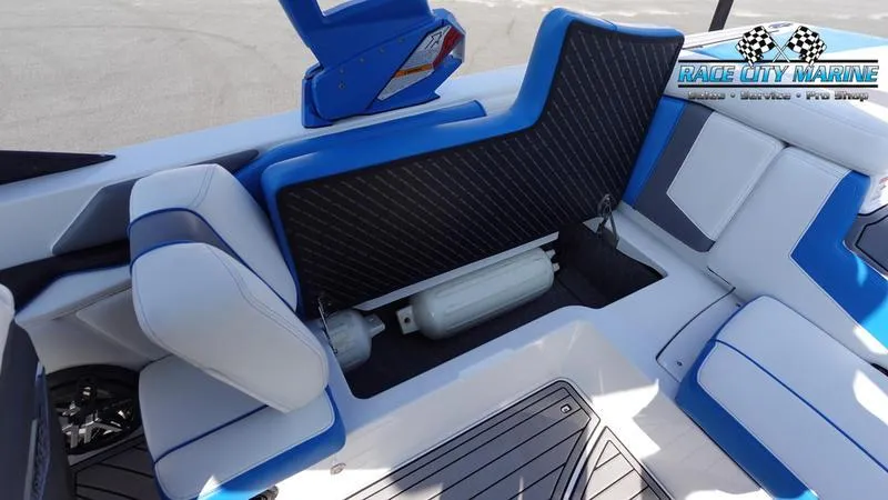 Slide: The Image of 2019 Nautique Super Air Nautique 230 interior seating with storage compartment open. - 30