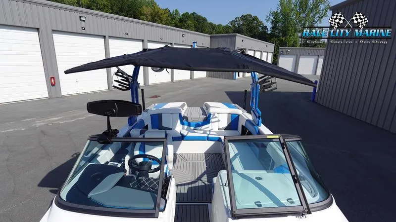 Slide: The Image of 2019 Nautique Super Air Nautique 230 boat with canopy in storage facility. - 37