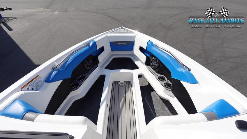 Slide: The Image of 2019 Nautique Super Air Nautique 230 boat interior with blue and white seating. - 38