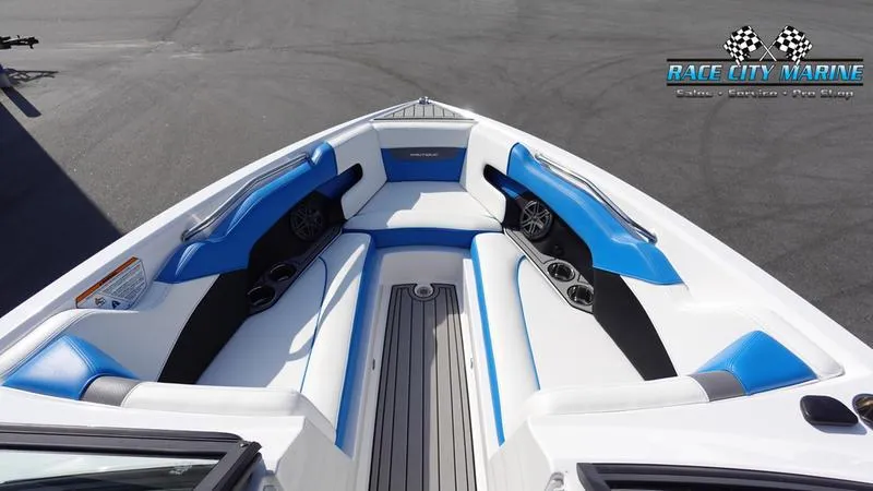 Slide: The Image of 2019 Nautique Super Air Nautique 230 boat interior with blue and white seating. - 39
