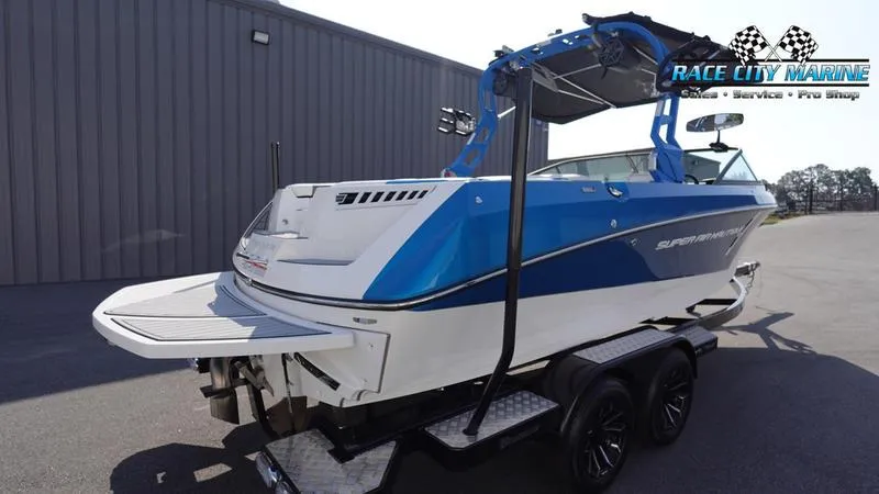 Slide: The Image of 2019 Nautique Super Air Nautique 230 boat, blue and white, on a trailer at Race City Marine. - 6