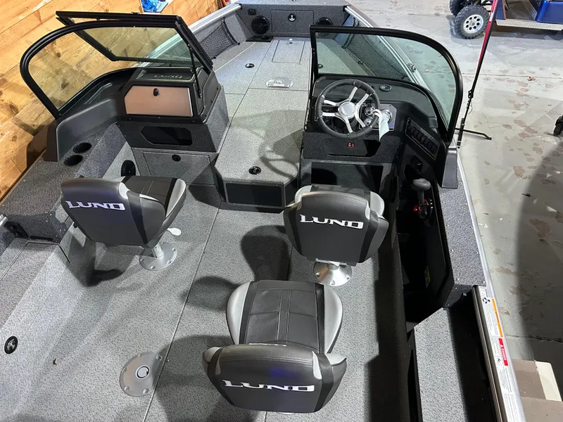 Slide: The Image of 2025 Lund Impact XS 1875 Sport boat interior with dual seats and steering console. - 10