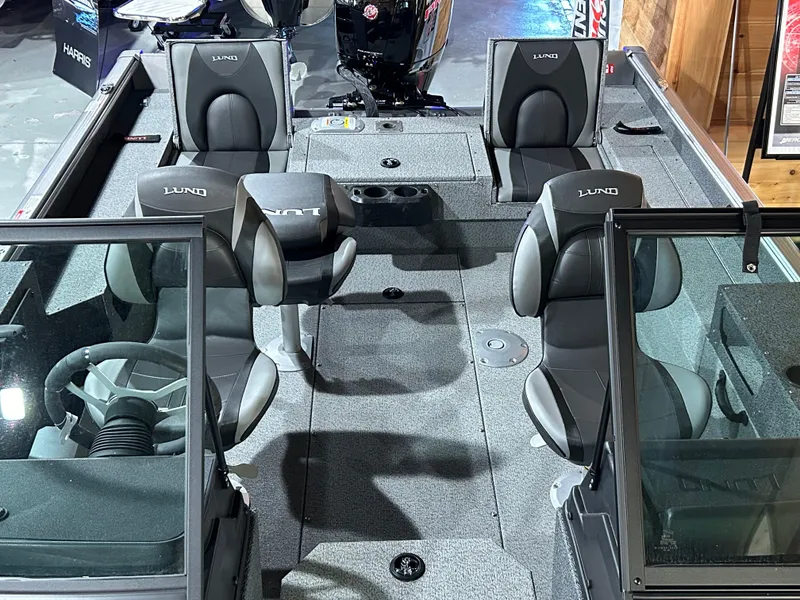 Slide: The Image of 2025 Lund Impact XS 1875 Sport boat interior with seating and steering wheel. - 12