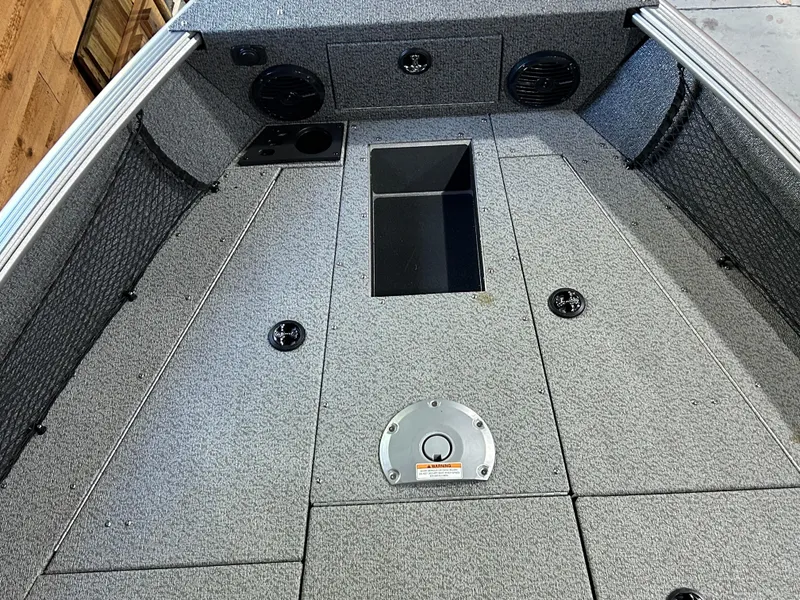 Slide: The Image of 2025 Lund Impact XS 1875 Sport boat interior with storage compartments and speakers. - 13