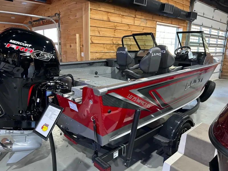 Slide: The Image of 2025 Lund Impact XS 1875 Sport boat with Mercury Pro XS engine in a wooden garage. - 3