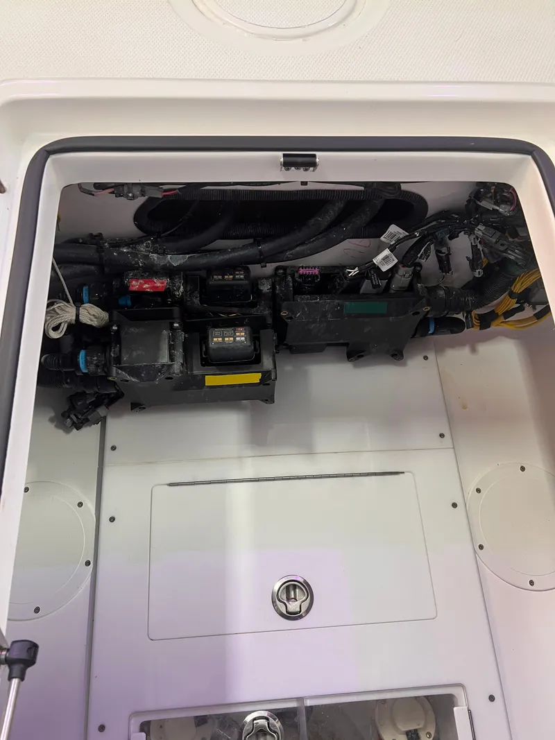 Slide: The Image of 2024 SeaHunter 35 Tournament boat electrical compartment with wiring and components. - 19