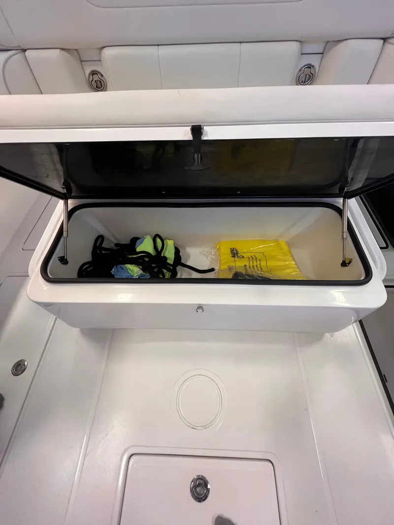 Slide: The Image of Open storage compartment on 2024 SeaHunter 35 Tournament boat with gear inside. - 20