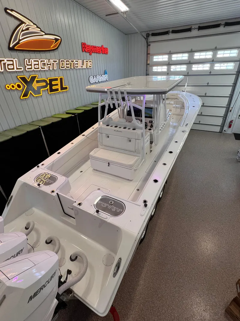 Slide: The Image of 2024 SeaHunter 35 Tournament boat in showroom, featuring dual Mercury engines. - 24