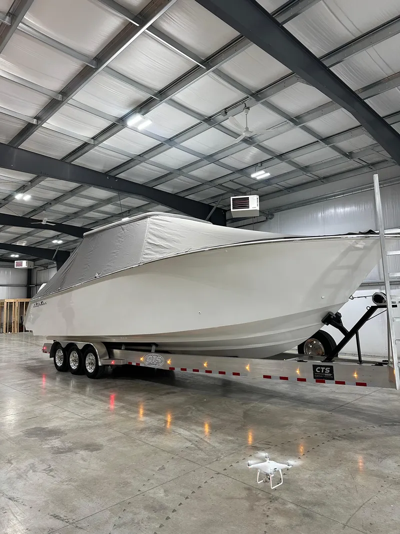 Slide: The Image of 2024 SeaHunter 35 Tournament boat on trailer in a warehouse. - 28