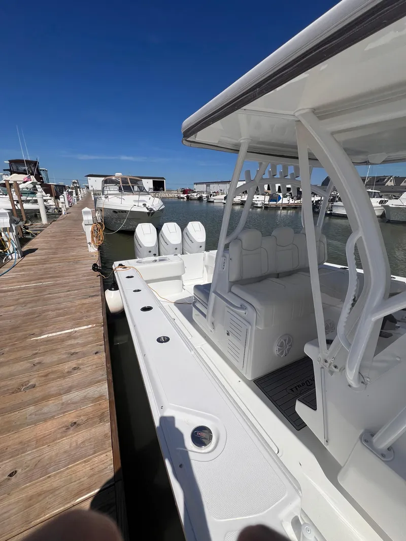 Slide: The Image of 2024 SeaHunter 35 Tournament boat docked at marina under clear blue sky. - 3