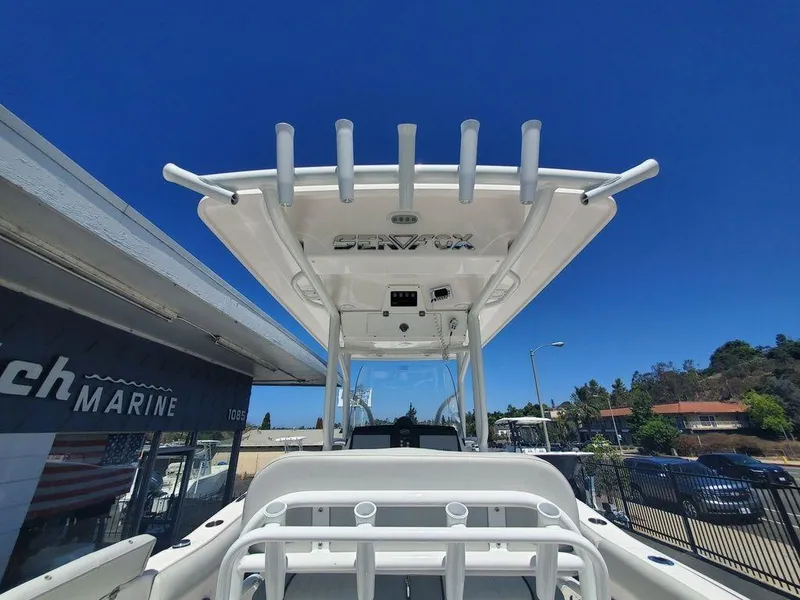 Slide: The Image of 2022 Sea Fox 268 Commander boat with T-top, displayed outdoors under clear blue sky. - 20
