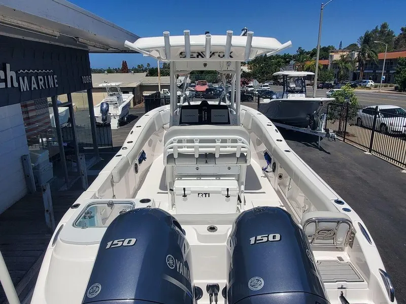 Slide: The Image of 2022 Sea Fox 268 Commander boat with twin Yamaha 150 engines at a marina. - 39