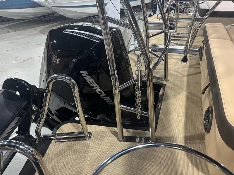 Slide: The Image of 2025 Harris Sunliner 230 SL boat with Mercury engine, featuring sleek chrome railings and beige seating. - 10