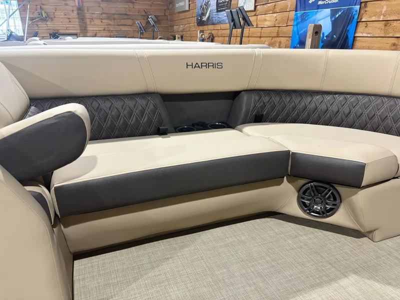 Slide: The Image of Luxurious seating in 2025 Harris Sunliner 230 SL boat with elegant upholstery and speaker system. - 2