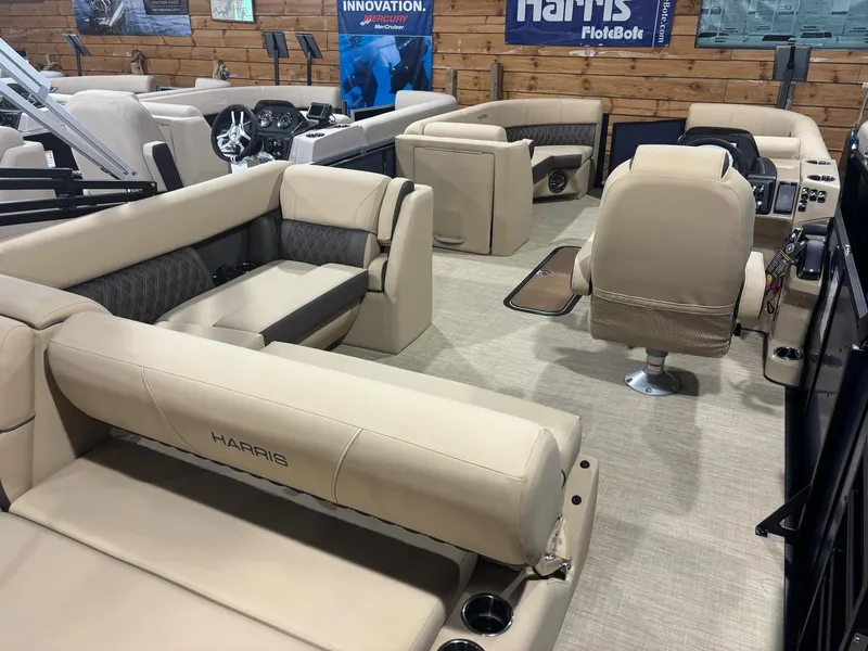 Slide: The Image of 2025 Harris Sunliner 230 SL pontoon boat interior with beige seating and modern design. - 5