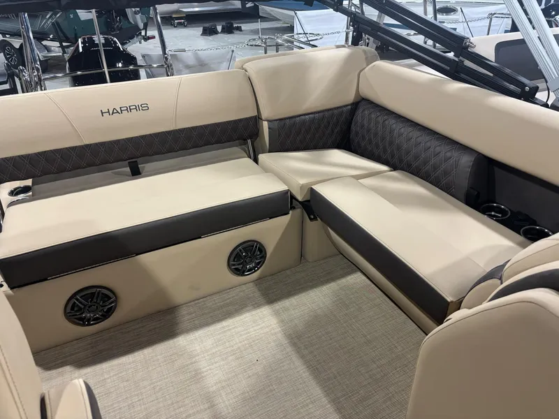 Slide: The Image of 2025 Harris Sunliner 230 SL interior with beige seating and built-in speakers. - 6