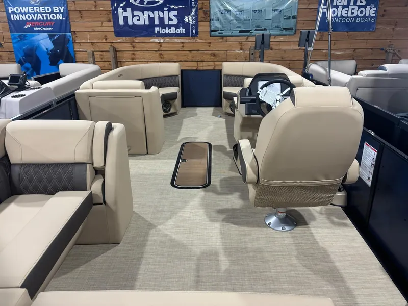 Slide: The Image of Interior of 2025 Harris Sunliner 230 SL pontoon boat with beige seating and steering console. - 7