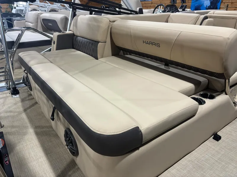 Slide: The Image of 2025 Harris Sunliner 230 SL boat interior with beige seating and cup holders. - 8